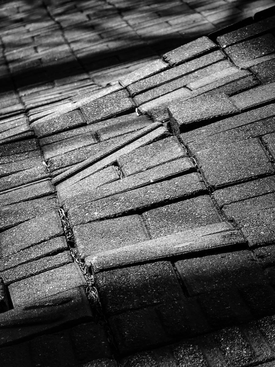 Close-up of asphalt shingles damaged by hail impact