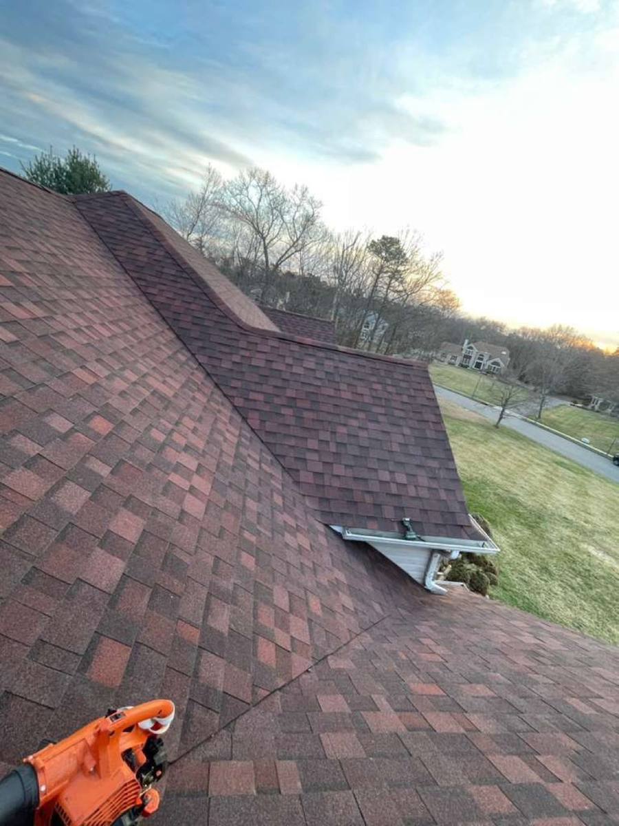 Freshly installed grey shingles at golden hour