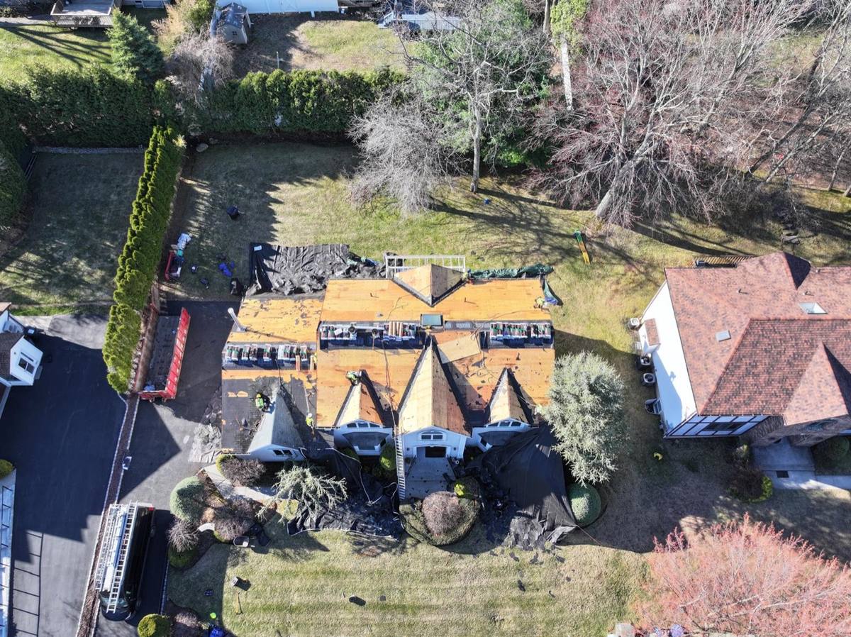 Aerial drone shot of a Storm Division project mid-replacement  - decking exposed, crew on site